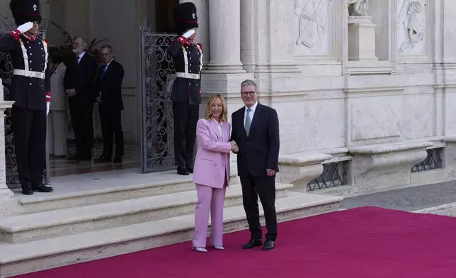 Italian Premier Giorgia Meloni, left, welcomes U.K. Prime Minister Keir Starmer as they meet at Villa Panphilj in Rome, Monday, Sept. 16, 2024. U.K. Prime Minister Keir Starmer is meeting Italian Premier Giorgia Meloni in Rome on Monday, as the two very different politicians, from left and right, seek common cause to curb migrants reaching their shores by boat. The visit comes after at least eight seaborne migrants died off the French coast over the weekend. (AP Photo Andrew Medichini)