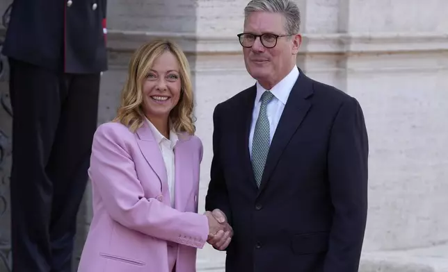 Italian Premier Giorgia Meloni, left, welcomes U.K. Prime Minister Keir Starmer as they meet at Villa Panphilj in Rome, Monday, Sept. 16, 2024. U.K. Prime Minister Keir Starmer is meeting Italian Premier Giorgia Meloni in Rome on Monday, as the two very different politicians, from left and right, seek common cause to curb migrants reaching their shores by boat. The visit comes after at least eight seaborne migrants died off the French coast over the weekend. (AP Photo Andrew Medichini)