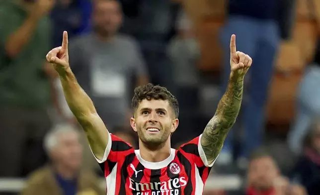 AC Milan's Christian Pulisic celebrates scoring his side's opening goal during the Champions League opening phase soccer match between AC Milan and Liverpool at the San Siro stadium in Milan, Italy, Tuesday, Sept. 17, 2024. (Spada/LaPresse via AP)