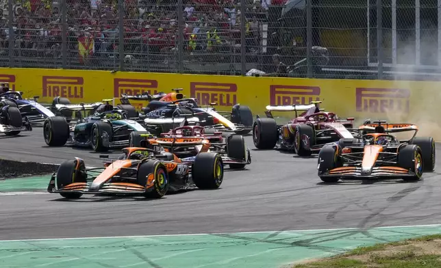 McLaren driver Lando Norris of Britain, left, leads the field after the start during the Formula One Italian Grand Prix race at the Monza racetrack, in Monza, Italy, Sunday, Sept. 1, 2024. (AP Photo/Luca Bruno)