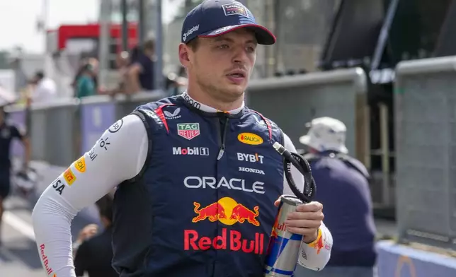 Red Bull driver Max Verstappen of the Netherlands is on his way to the starting grid before the Formula One Italian Grand Prix race at the Monza racetrack, in Monza, Italy, Sunday, Sept. 1, 2024. (AP Photo/Luca Bruno)