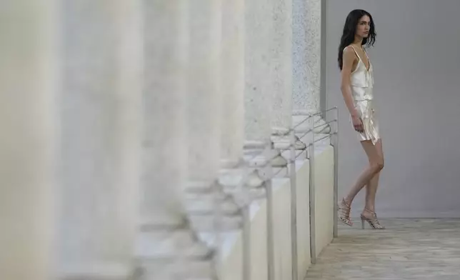 A model wears a creation as part of the Alberta Ferretti Spring Summer 2025 collection, that was presented in Milan, Italy, Tuesday, Sept. 17, 2024. (AP Photo/Luca Bruno).