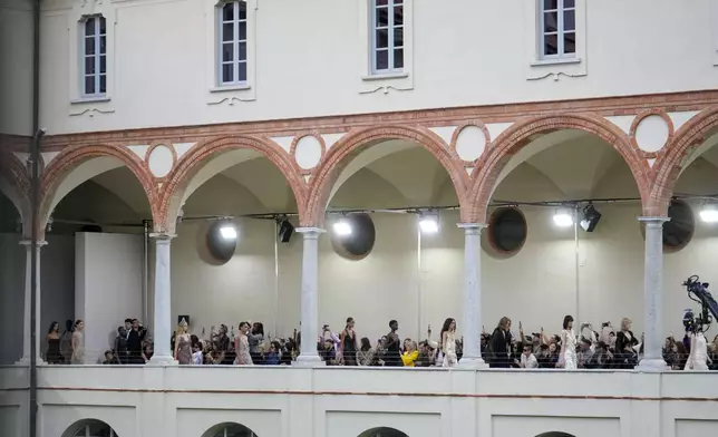 Models wear creations as part of the Alberta Ferretti Spring Summer 2025 collection, that was presented in Milan, Italy, Tuesday, Sept. 17, 2024. (AP Photo/Luca Bruno).