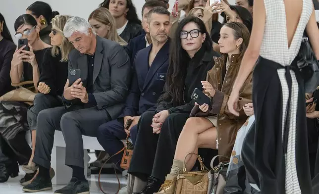 Marina Abramovic, second from right front row, attends the Fendi Spring Summer 2025 collection, that was presented in Milan, Italy, Tuesday, Sept. 17, 2024. (AP Photo/Luca Bruno).