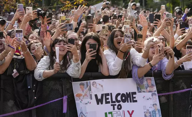 Fans react as musician Jin departs the Gucci Spring Summer 2025 collection, that was presented in Milan, Italy, Friday, Sept. 20, 2024. (AP Photo/Luca Bruno).