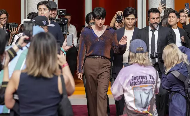 Jin departs the Gucci Spring Summer 2025 collection, that was presented in Milan, Italy, Friday, Sept. 20, 2024. (AP Photo/Luca Bruno).