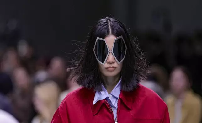 A model wears a creation as part of the Prada Spring Summer 2025 collection, that was presented in Milan, Italy, Thursday, Sept. 19, 2024. (AP Photo/Luca Bruno).