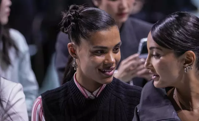 Tina Kunakey, centre, attends the Prada Spring Summer 2025 collection, that was presented in Milan, Italy, Thursday, Sept. 19, 2024. (AP Photo/Luca Bruno).