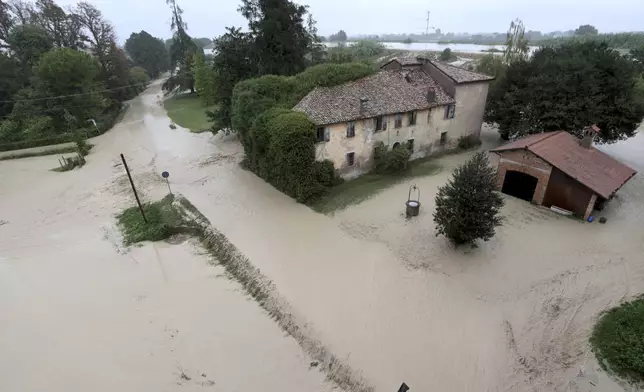 The Lamone river overflows its banks near Bagnacavallo, in the region of Emilia-Romagna, Italy, Thursday, Sept. 19, 2024. (Fabrizio Zani/LaPresse via AP)