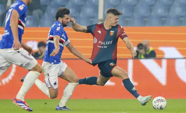 Genoa's Vitinha, right, looks to play the ball as Sampdoria's Bartosz Bereszynski closes in during an Italian Cup soccer match between Genoa and Sampdoria at Luigi Ferraris Stadium, Wednesday, Sept. 25, 2024, in Genoa, Italy. (Tano Pecoraro/LaPresse via AP)