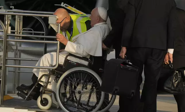 Pope Francis arrives at Fiumicino International airport Leonardo da Vinci, some 30 kilometers south-west of Rome, Thursday, Sept. 26, 2024 to board the papal flight to Luxembourg for a four-day visit to Luxembourg and Belgium. (AP Photo/Gregorio Borgia)