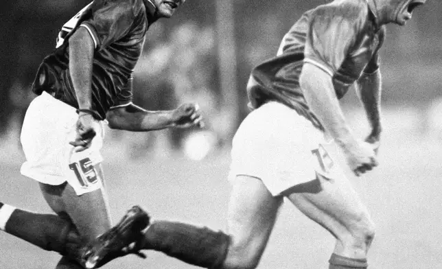 Italy's Salvatore "Totò Schillaci, right, celebrates with teammate Roberto Baggio after scoring a goal during the World Cup soccer match between Italy and Uruguay, in Rome, on June 25, 1990. (LaPresse via AP)