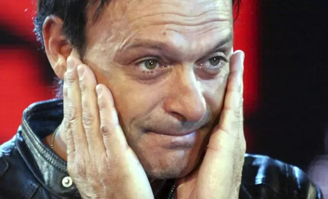 FILE- Former Italian striker Salvatore "Totò" Schillaci is overcome by emotion as he arrives at the reality show "L'Isola dei Famosi" in Milan, Italy, Friday, Nov. 19, 2004. (AP Photo/Antonio Calanni, file)