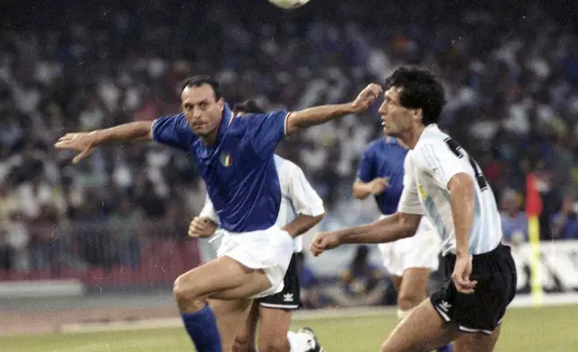 FILE - Italy's Salvatore "Totò" Schillaci, left, and Argentina's Juan Simon chase the ball during the Soccer World Cup semi-final, in Naples, Italy, July 3, 1990. (AP Photo, file)