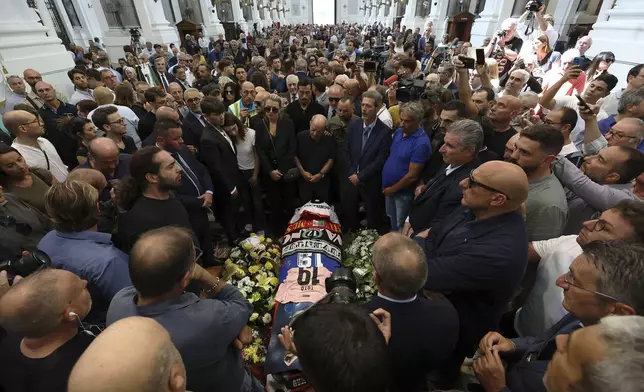 Mourners gather next to the coffin of Italian World Cup hero Salvatore Toto' Schillaci, during his funeral ceremony at the Palermo cathedral, Italy, Friday, Sept. 20, 2024. (Alberto Lo Bianco/LaPresse via AP)