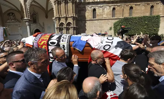 Pallbearers carry the coffin of Italian World Cup hero Salvatore Toto' Schillaci, during his funeral ceremony at the Palermo cathedral, Italy, Friday, Sept. 20, 2024. (Alberto Lo Bianco/LaPresse via AP)