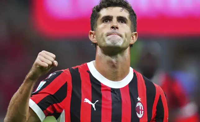 AC Milan's Christian Pulisic celebrates after scoring in a Serie A soccer match between AC Milan and Venezia at the San Siro Stadium in Milan, Italy, Saturday, Sept. 14, 2024. (Spada/LaPresse via AP)