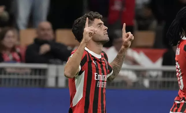 AC Milan's Christian Pulisic celebrates scoring his side's opening goal during the Champions League opening phase soccer match between AC Milan and Liverpool at the San Siro stadium in Milan, Italy, Tuesday, Sept. 17, 2024. (AP Photo/Luca Bruno)