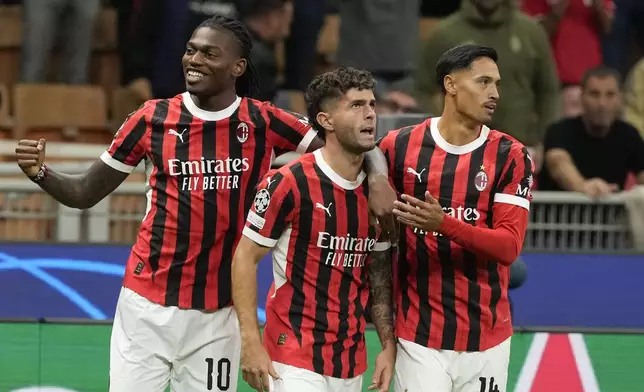 AC Milan's Christian Pulisic, center, is congratulated after scoring his side's opening goal during the Champions League opening phase soccer match between AC Milan and Liverpool at the San Siro stadium in Milan, Italy, Tuesday, Sept. 17, 2024. (AP Photo/Luca Bruno)