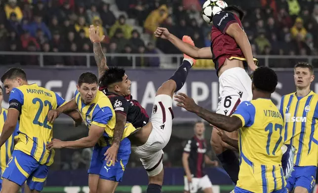 Bologna's Santiago Castro, third left, and Bologna's Nikola Moro, top, during the Champions League opening phase soccer match between FC Bologna and Shakhtar Donetsk in Bologna, Italy, Wednesday, Sept. 18, 2024. (Massimo Paolone/LaPresse via AP)