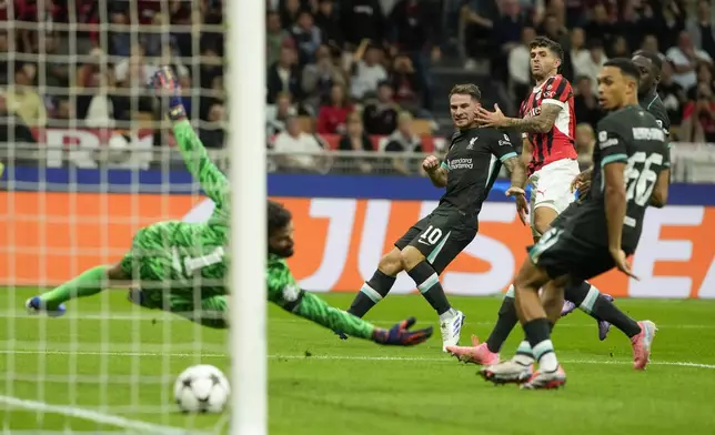 AC Milan's Christian Pulisic, second from right, scores his side's opening goal during the Champions League opening phase soccer match between AC Milan and Liverpool at the San Siro stadium in Milan, Italy, Tuesday, Sept. 17, 2024. (AP Photo/Luca Bruno)