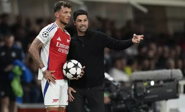 Arsenal's manager Mikel Arteta, right, and Ben White talk during the Champions League opening phase soccer match between Atalanta and Arsenal at the Bergamo's stadium in Bergamo, Italy, Thursday, Sept. 19, 2024. (AP Photo/Antonio Calanni)