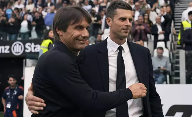 Juventus' head coach Thiago Motta, ight, and Napoli's head coach Antonio Conte, left, before the Serie A soccer match between Juventus FC and SSC Napoli in Turin, Italy, Saturday, Sept. 21, 2024. (Fabio Ferrari/LaPresse via AP)