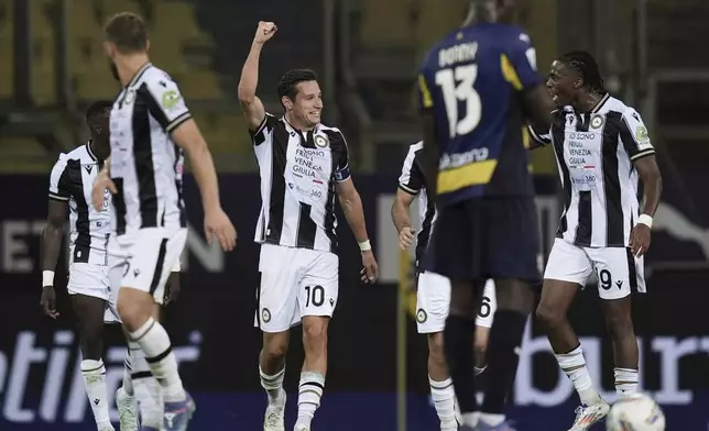 Udinese's Florian Thauvin, center, celebrates after scoring his side's third goal during the Serie A soccer match between Parma and Udinese in Parma, Italy, Monday Sept. 16, 2024 (Massimo Paolone/LaPresse via AP)