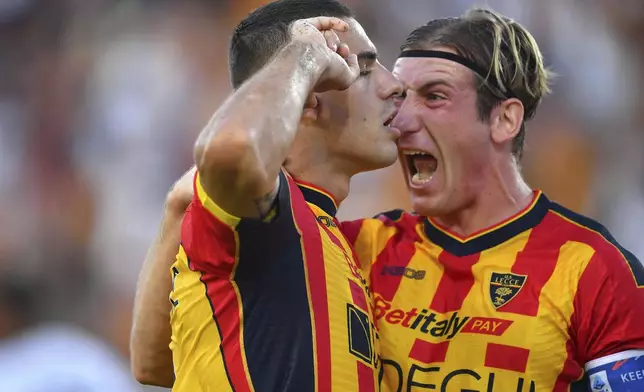 Lecce's Nikola Krstovic, left, celebrates scoring during the Serie A soccer match between US Lecce and Cagliari Calcio at the Via del Mare Stadium in Lecce, Italy, Saturday, Aug. 31, 2024. (Giovanni Evangelista/LaPresse via AP)