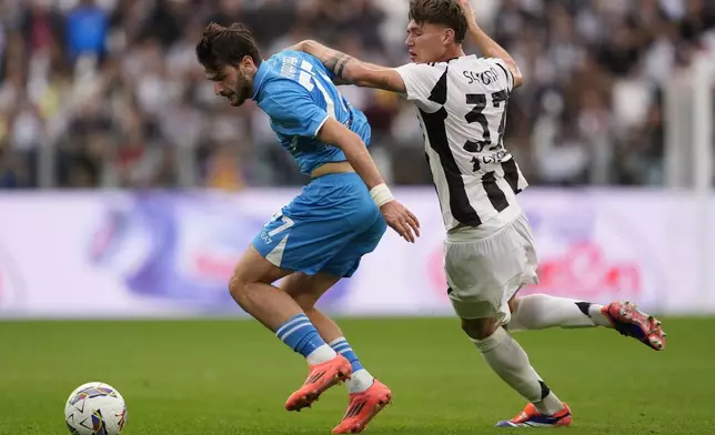 Juventus' SSC 'Nicolo' Savona, right, and Napoli's Khvicha Kvaratskhelia, left, challenge for the ball during the Serie A soccer match between Juventus FC and SSC Napoli in Turin, Italy, Saturday, Sept. 21, 2024. (Fabio Ferrari/LaPresse via AP)