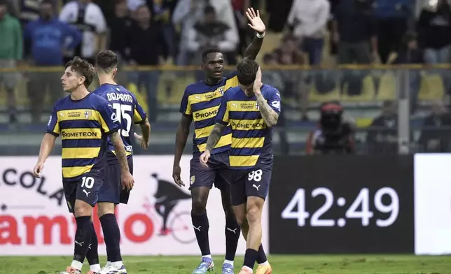 Parma's Ange Yoan Bonny, second right, celebrates after scoring his side's second goal during the Serie A soccer match between Parma and Udinese in Parma, Italy, Monday Sept. 16, 2024 (Massimo Paolone/LaPresse via AP)