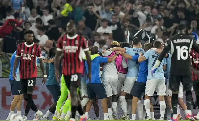 Lazio players, in the background, celebrate after Lazio's Boulaye Dia scored their second goal during a Serie A soccer match between Lazio and AC Milan, at Rome's Stadio Olimpico, Saturday, Aug. 31, 2024. (AP Photo/Andrew Medichini)