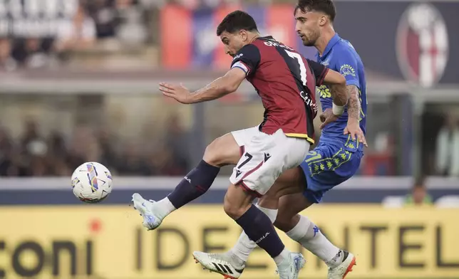 Bologna's Riccardo Orsolini fights for the ball with Empoli's Mattia Viti, right, during the Serie A soccer match between Bologna and Empoli at Renato Dall'Ara Stadium, Bologna, Italy, Saturday Aug. 31, 2024. (Massimo Paolone/LaPresse via AP)