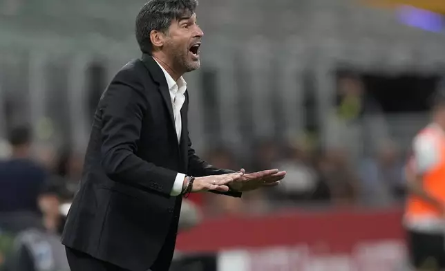 AC Milan's head coach Paulo Fonseca gives instructions during the Serie A soccer match between AC Milan and Venezia at the San Siro stadium, in Milan, Italy, Saturday, Sept. 14, 2024. (AP Photo/Antonio Calanni)