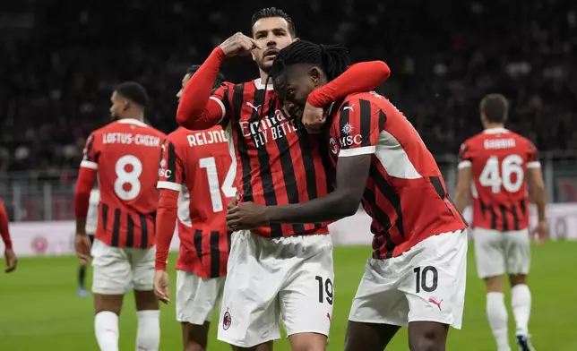 AC Milan's Theo Hernandez, left, celebrates after he scored with Rafael Leaoduring the Serie A soccer match between AC Milan and Venezia at the San Siro stadium, in Milan, Italy, Saturday, Sept. 14, 2024. (AP Photo/Antonio Calanni)