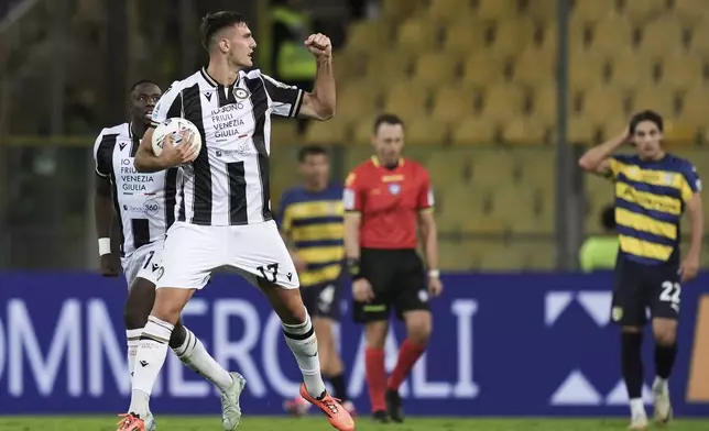 Udinese's Lorenzo Lucca, front, celebrates after scoring his side's first goal during the Serie A soccer match between Parma and Udinese in Parma, Italy, Monday Sept. 16, 2024 (Massimo Paolone/LaPresse via AP)