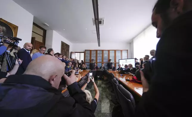 National Anti-Mafia Prosecutor Giovanni Milillo, center left, and Milan's Prosecutor Marcello Viola, center right, attend a news conference at the Milan's court, in Milan, Italy, Monday, Sept. 30, 2024. (AP Photo/Luca Bruno)
