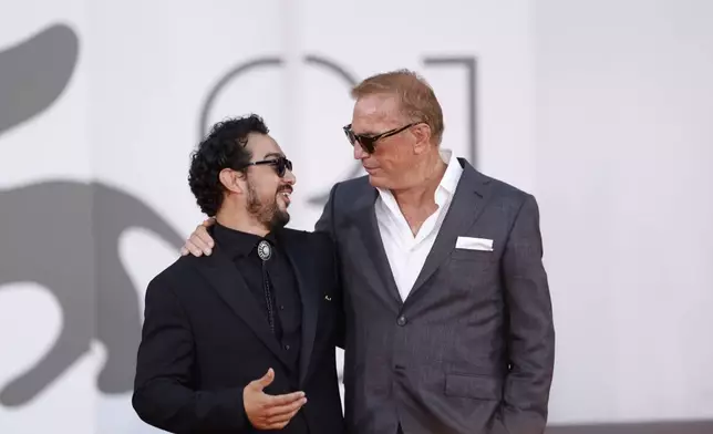 Alejandro Edda, left, and Kevin Costner pose for photographers upon arrival at the closing ceremony of the 81st edition of the Venice Film Festival in Venice, Italy, on Saturday, Sept. 7, 2024(Photo by Vianney Le Caer/Invision/AP)