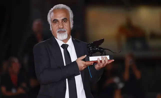 Director Nader Saeivar, winner of the armani beauty audience award for the film 'The witness', poses for photographers at the awards photo call during the closing ceremony of the 81st edition of the Venice Film Festival in Venice, Italy, on Saturday, Sept. 7, 2024. (Photo by Vianney Le Caer/Invision/AP)