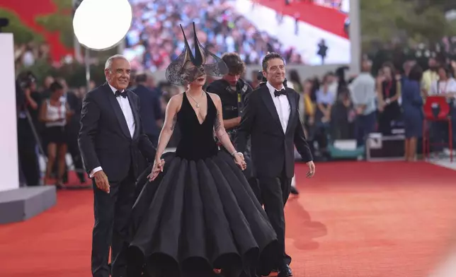 Venice Film Festival Artistic Director Alberto Barbera, from left, Lady Gaga and Pietrangelo Buttafuoco pose for photographers upon arrival for the premiere of the film 'Joker: Folie A Deux' during the 81st edition of the Venice Film Festival in Venice, Italy, on Wednesday, Sept. 4, 2024. (Photo by Vianney Le Caer/Invision/AP)