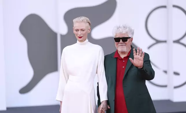 Tilda Swinton, left, and Pedro Almodovar pose for photographers upon arrival for the premiere of the film 'Queer' during the 81st edition of the Venice Film Festival in Venice, Italy, on Tuesday, Sept. 3, 2024. (Photo by Vianney Le Caer/Invision/AP)