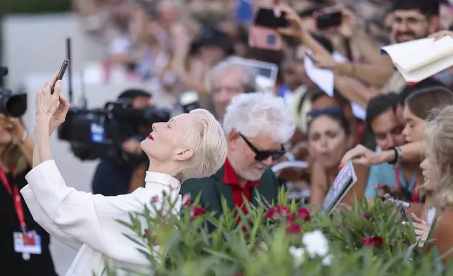 Tilda Swinton takes a selfie upon arrival for the premiere of the film 'Queer' during the 81st edition of the Venice Film Festival in Venice, Italy, on Tuesday, Sept. 3, 2024. (Photo by Vianney Le Caer/Invision/AP)