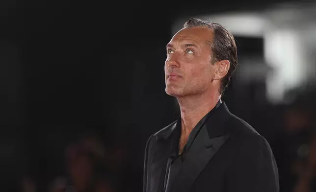 Jude Law poses for photographers upon arrival for the premiere of the film 'The Order' during the 81st edition of the Venice Film Festival in Venice, Italy, on Saturday, Aug. 31, 2024. (Photo by Vianney Le Caer/Invision/AP)