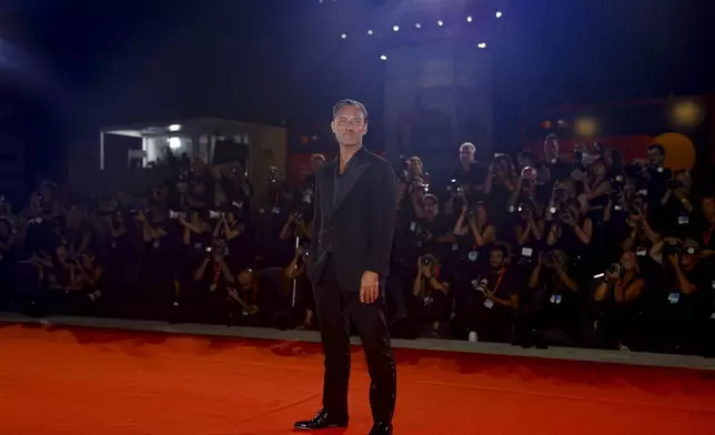 Jude Law poses for photographers upon arrival for the premiere of the film 'The Order' during the 81st edition of the Venice Film Festival in Venice, Italy, on Saturday, Aug. 31, 2024. (Photo by Vianney Le Caer/Invision/AP)