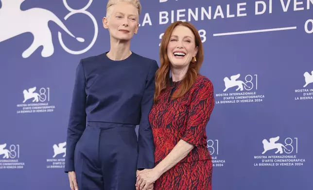 Tilda Swinton, left, and Julianne Moore pose for photographers at the photo call for the film 'The Room Next Door' during the 81st edition of the Venice Film Festival in Venice, Italy, on Monday, Sept. 2, 2024. (Photo by Vianney Le Caer/Invision/AP)