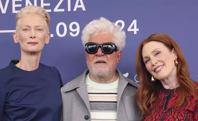 Tilda Swinton, from left, director Pedro Almodovar, and Julianne Moore pose for photographers at the photo call for the film 'The Room Next Door' during the 81st edition of the Venice Film Festival in Venice, Italy, on Monday, Sept. 2, 2024. (Photo by Vianney Le Caer/Invision/AP)