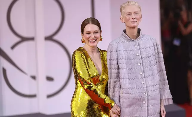 Julianne Moore, left, and Tilda Swinton pose for photographers upon arrival for the premiere of the film 'The Room Next Door' during the 81st edition of the Venice Film Festival in Venice, Italy, on Monday, Sept. 2, 2024. (Photo by Vianney Le Caer/Invision/AP)