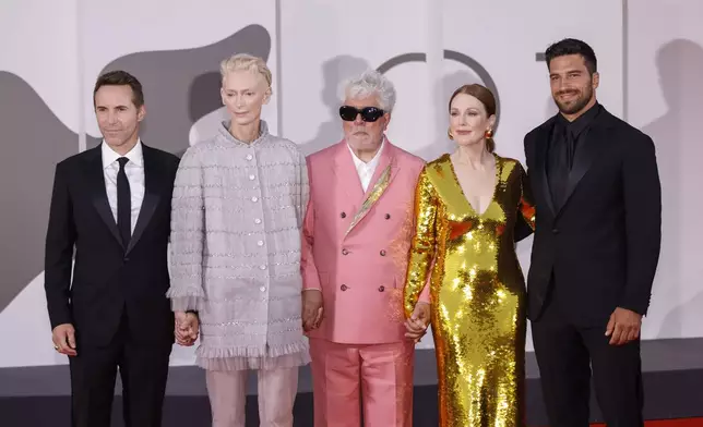 Alessandro Nivola, from left, Tilda Swinton, director Pedro Almodovar, Julianne Moore and Alvise Rigo pose for photographers upon arrival for the premiere of the film 'The Room Next Door' during the 81st edition of the Venice Film Festival in Venice, Italy, on Monday, Sept. 2, 2024. (Photo by Vianney Le Caer/Invision/AP)