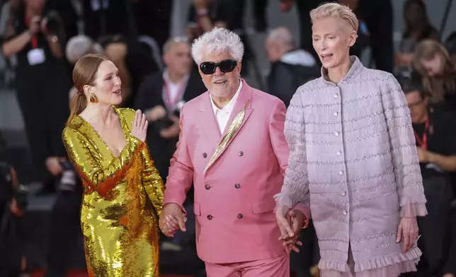 Julianne Moore, from left, director Pedro Almodovar, and Tilda Swinton pose for photographers upon arrival for the premiere of the film 'The Room Next Door' during the 81st edition of the Venice Film Festival in Venice, Italy, on Monday, Sept. 2, 2024. (Photo by Vianney Le Caer/Invision/AP)