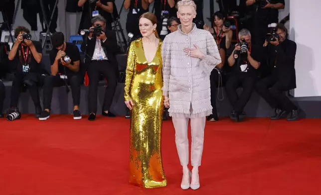 Julianne Moore, left, and Tilda Swinton pose for photographers upon arrival for the premiere of the film 'The Room Next Door' during the 81st edition of the Venice Film Festival in Venice, Italy, on Monday, Sept. 2, 2024. (Photo by Vianney Le Caer/Invision/AP)